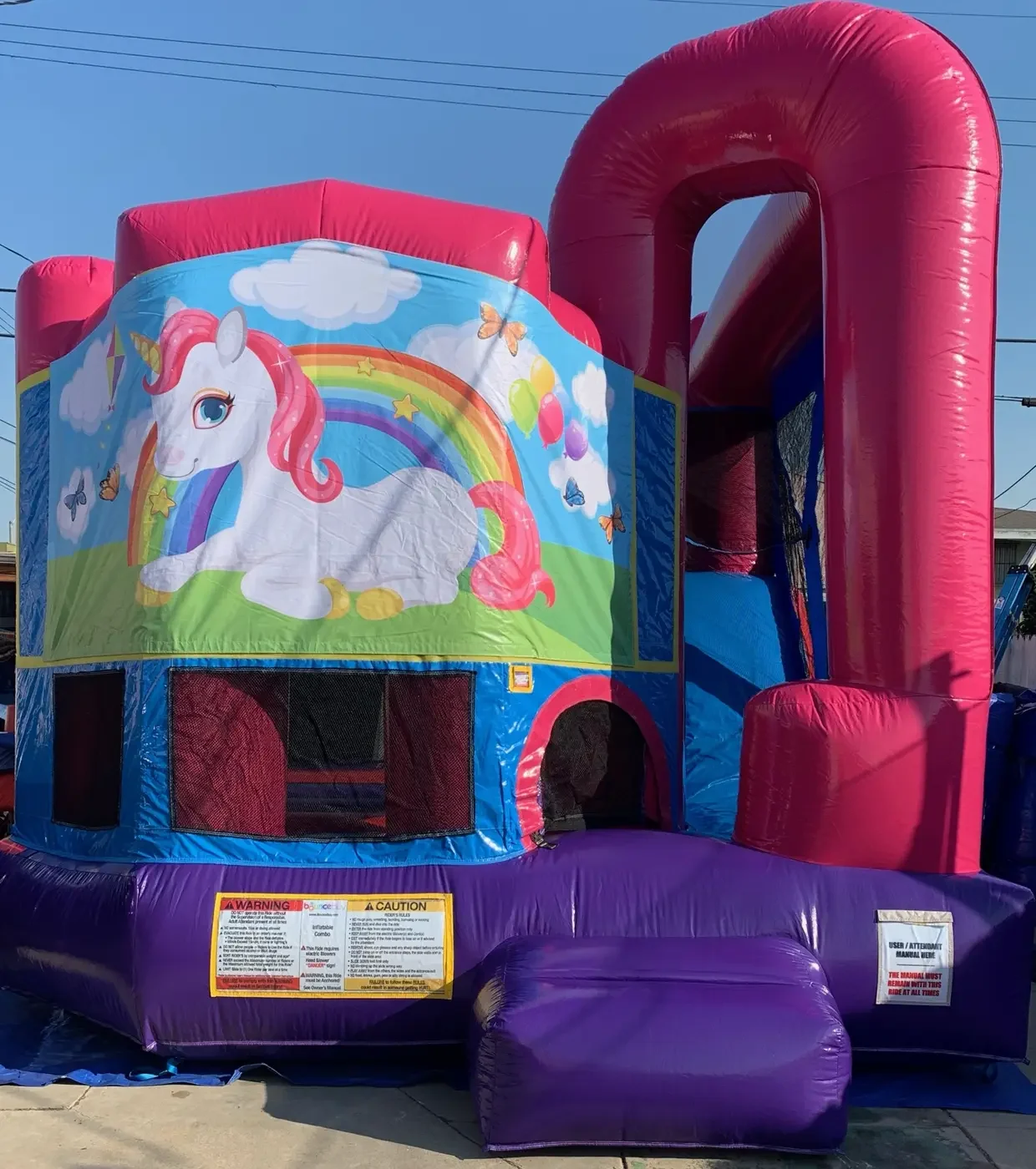 Unicorn themed pink and purple bounce house
