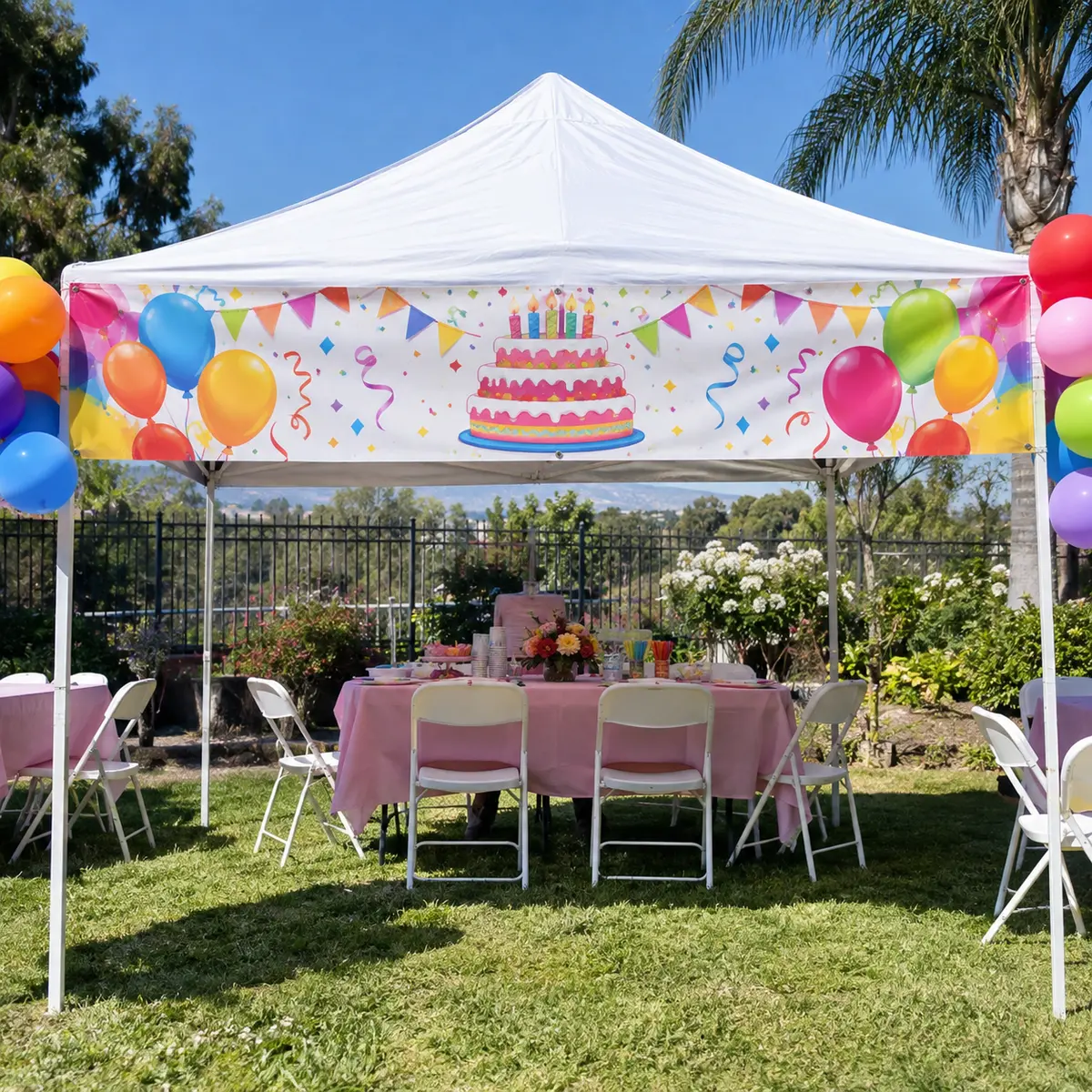Custom birthday banner installed on a party canopy